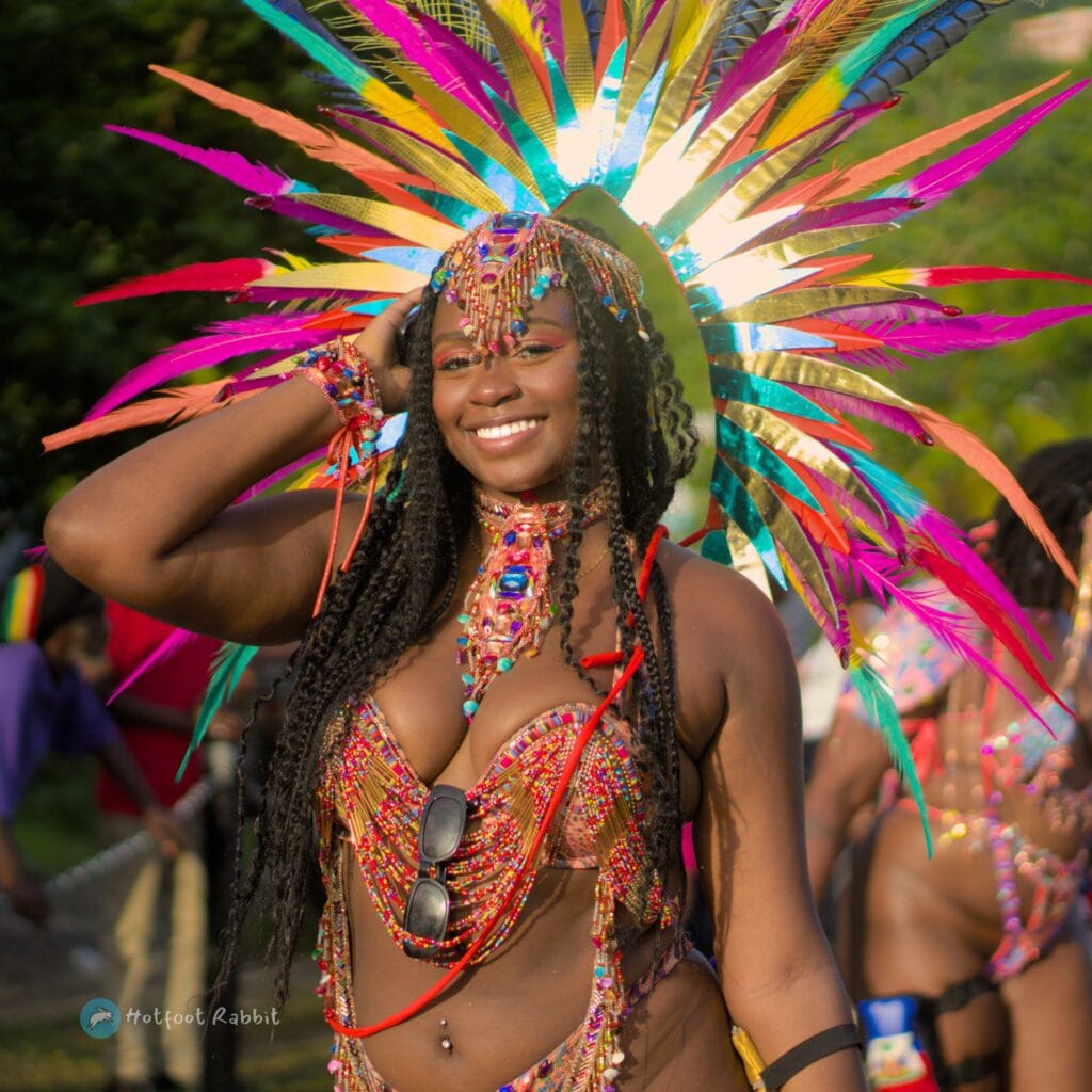 A beauty young woman smiling and posing while wearing a carnival costume in Grenada's spicemas carnival festival.